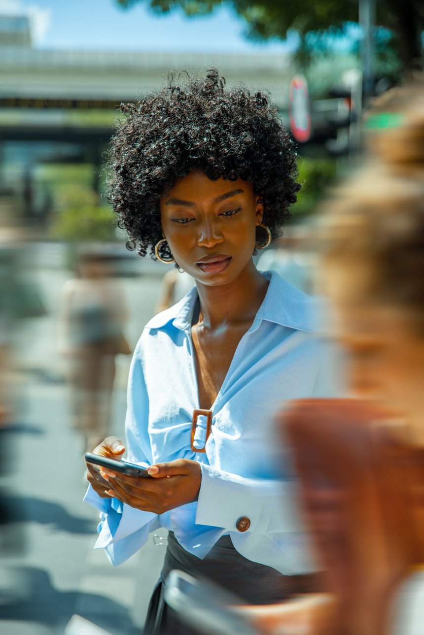 Woman Walking on a Busy Street